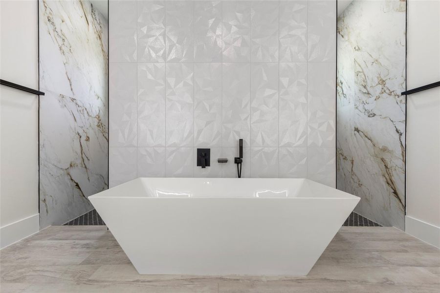 A superb stand-alone tub for soaking those long days away. Designer tiles offer a conversation piece from the moment you walk in the room. Shower entry from both sides. A superb stand-alone tub for soaking those long days away. Designer tiles offer a conversation piece from the moment you walk in the room. Shower entry from both sides.