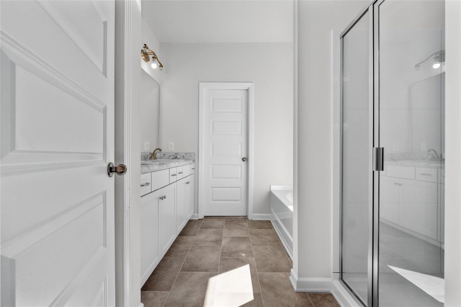 The Coleman- Primary Bathroom with Separate Tub and Shower. Home under construction, photo used for illustrative purposes only, colors and options will vary. The Coleman- Primary Bathroom with Separate Tub and Shower. Home under construction, photo used for illustrative purposes only, colors and options will vary.