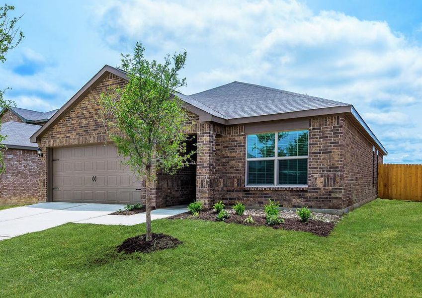 Stunning single-story home with front yard landscaping and a brick exterior.