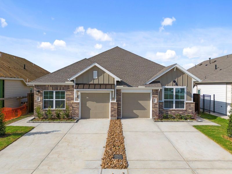 Front exterior of a new home in Meridiana, Iowa Colony, TX, highlighting curb appeal (Image 17).