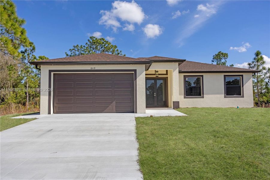 Front exterior of a new home in , Lehigh Acres, FL, highlighting curb appeal (Image 20).