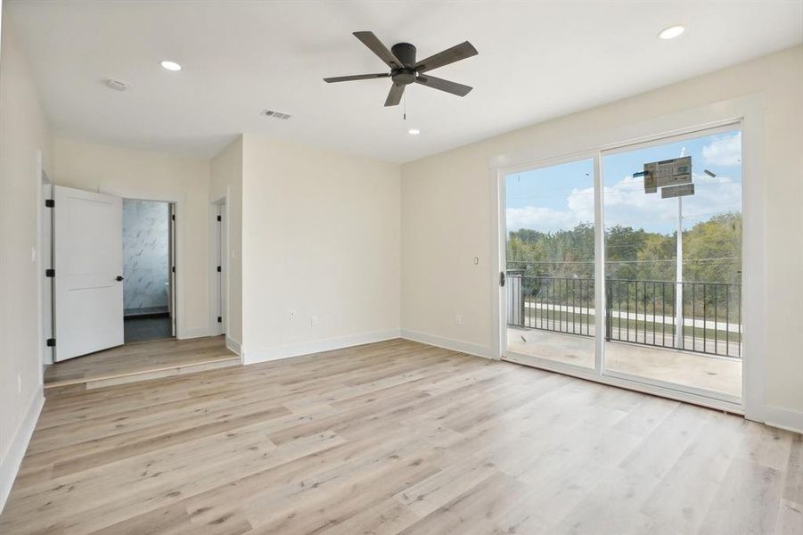 Unfurnished room featuring ceiling fan and light hardwood / wood-style flooring