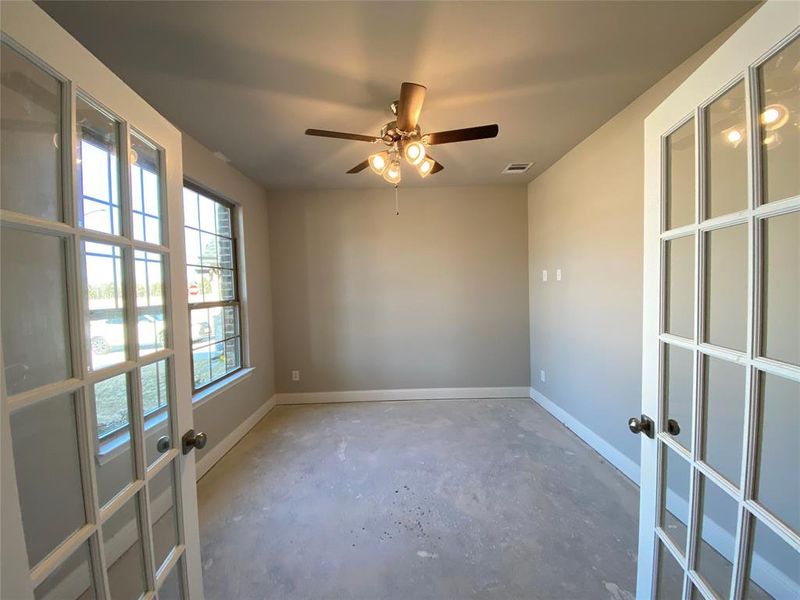 Study with French doors & ceiling fan. (Carpet not installed yet)