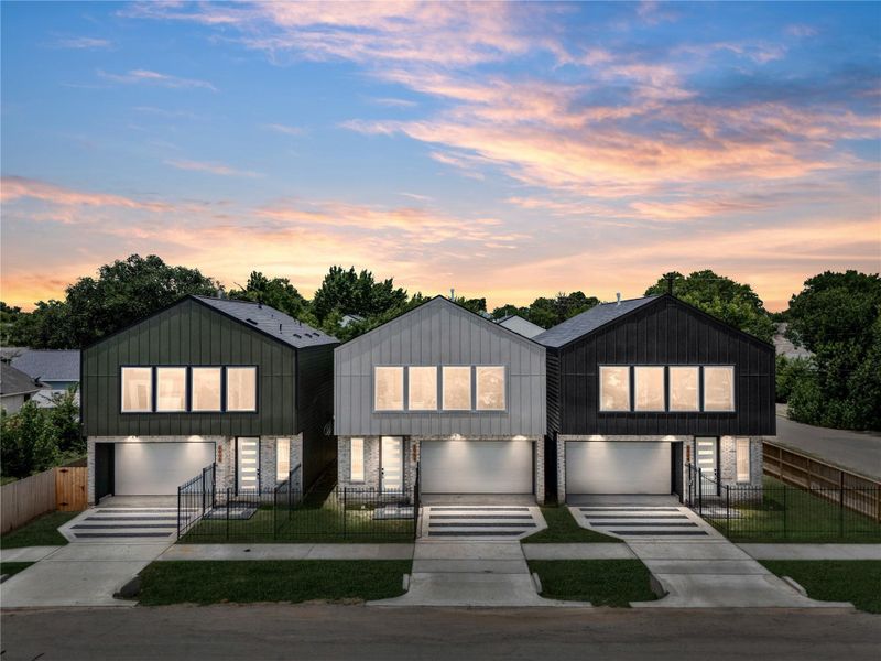 This trio of contemporary homes stands out even more after dark—each unit uniquely designed yet harmoniously cohesive with dramatic lighting and custom modern details.