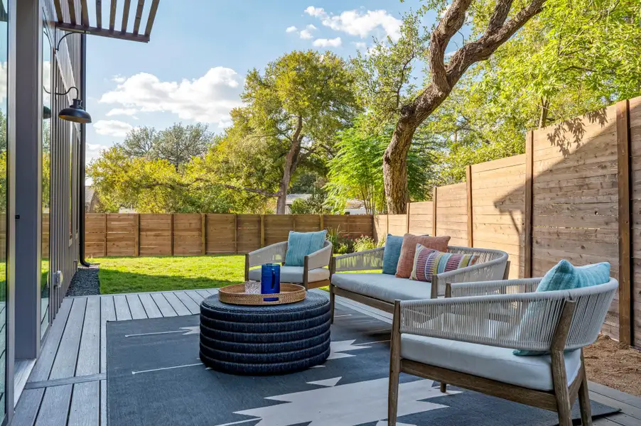 Fenced backyard with outdoor lounge area and a patio area Fenced backyard with outdoor lounge area and a patio area