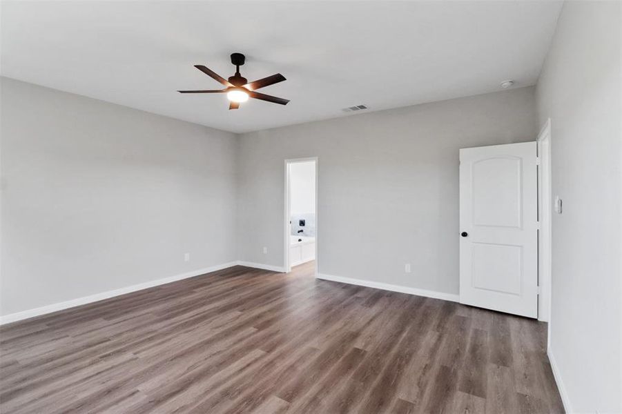 Unfurnished room featuring hardwood / wood-style flooring and ceiling fan