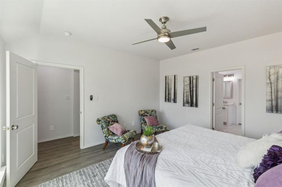 Bedroom featuring ensuite bath, ceiling fan, and light hardwood / wood-style floors