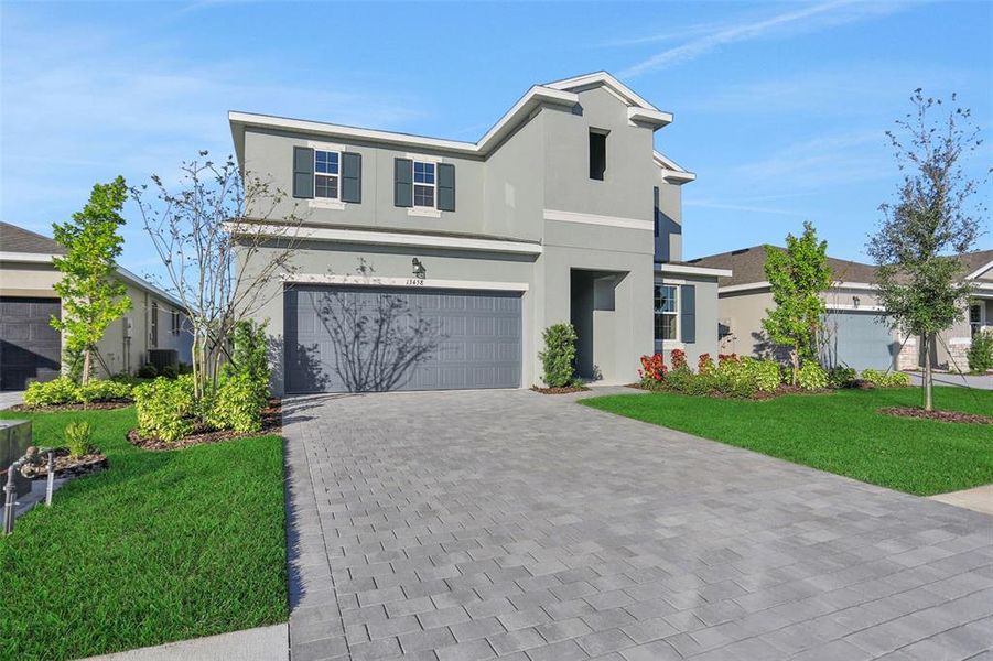 Front exterior of a new home in Turnleaf, Punta Gorda, FL, highlighting curb appeal (Image 22).