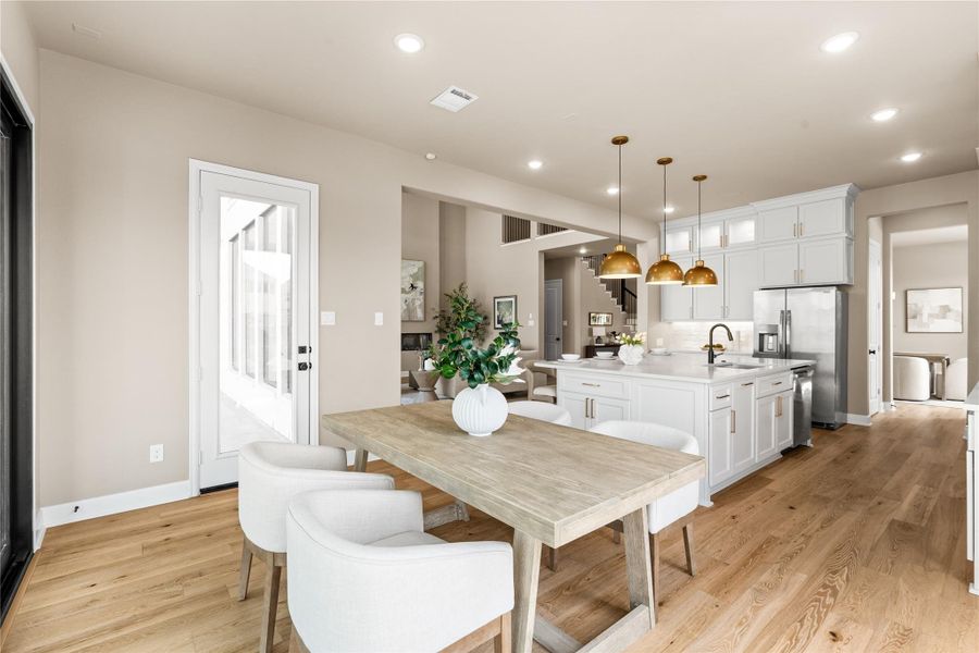Extend your living and dining space with this indoor / outdoor eating area. Bright and airy dining room featuring a sliding glass door, offering seamless access to a covered patio and a lush backyard. *Virtually Staged*