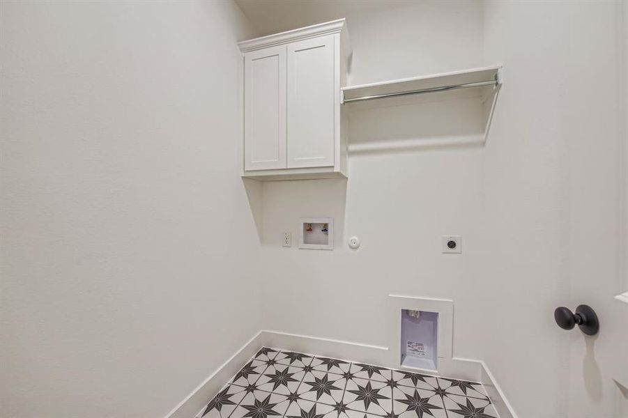Laundry room with hookup for a gas dryer, electric dryer hookup, hookup for a washing machine, and cabinet space