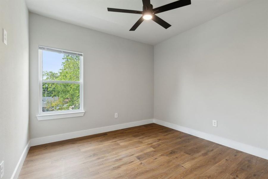 Unfurnished room featuring wood-type flooring and ceiling fan