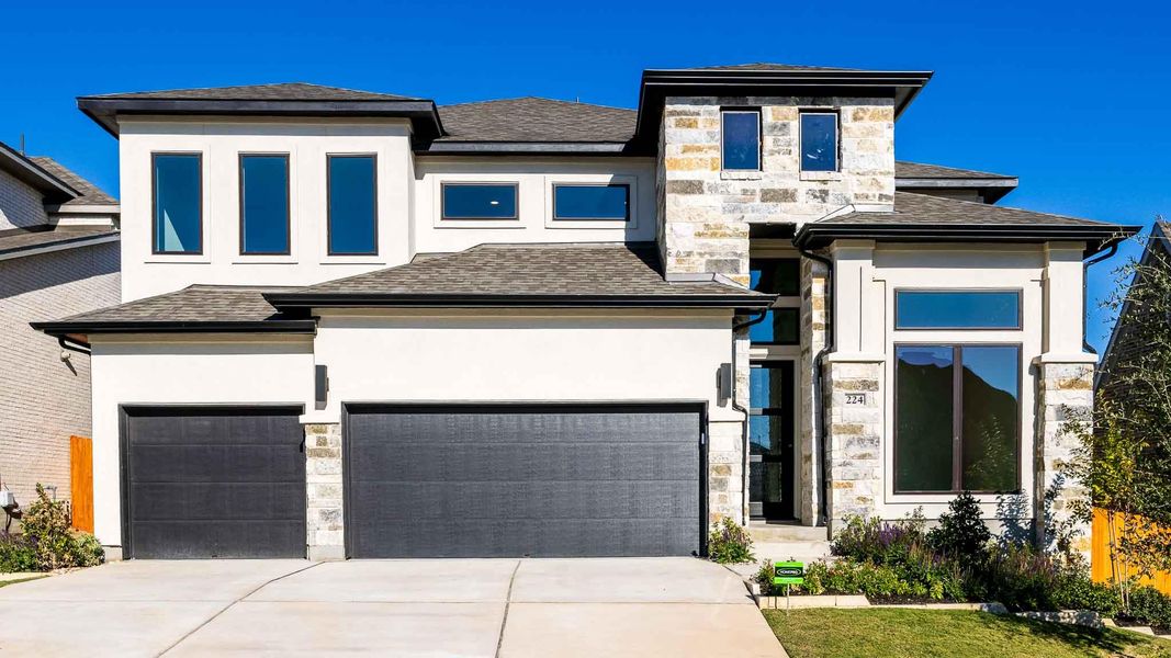Front exterior of a new home in Lariat 60', Liberty Hill, TX, highlighting curb appeal (Image 1). Front exterior of a new home in Lariat 60', Liberty Hill, TX, highlighting curb appeal (Image 1).