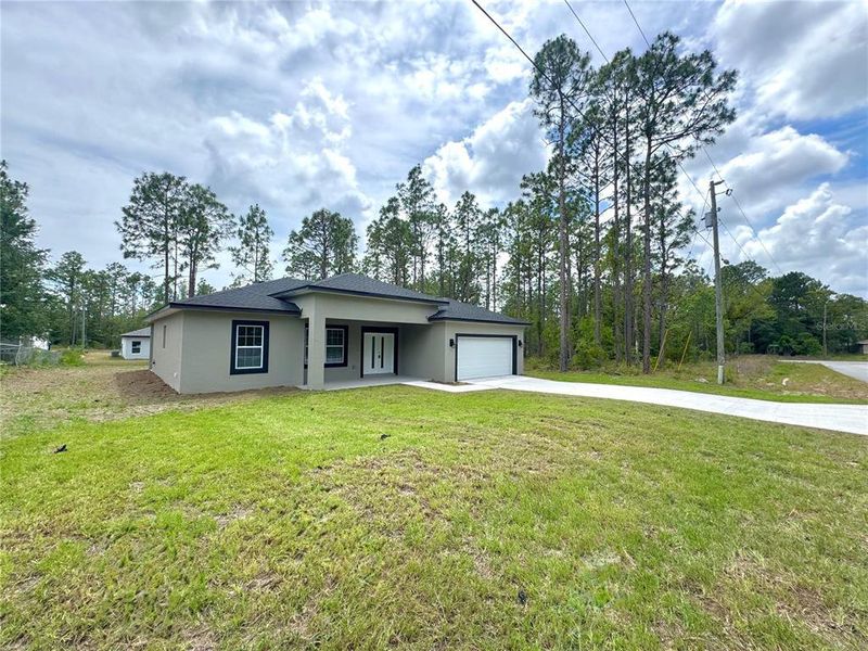Front exterior of a new home in , Dunnellon, FL, highlighting curb appeal (Image 18).