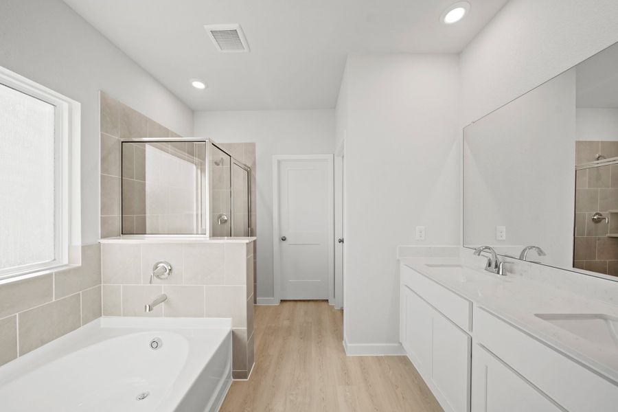 A bathroom with white cabinets. A bathroom with white cabinets.