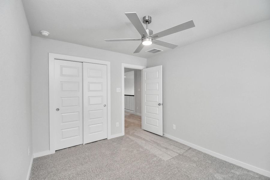 Generously sized secondary bedrooms featuring spacious closets, soft and inviting carpeting underfoot, large windows allowing plenty of natural light, and the added touch of privacy blinds for your personal retreat.
