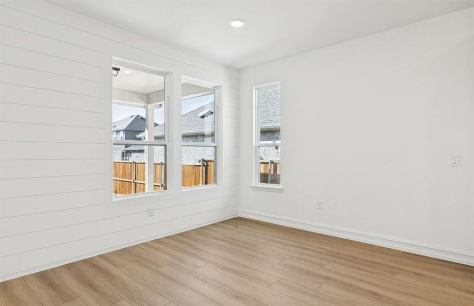 Dining nook off kitchen with large windows Dining nook off kitchen with large windows