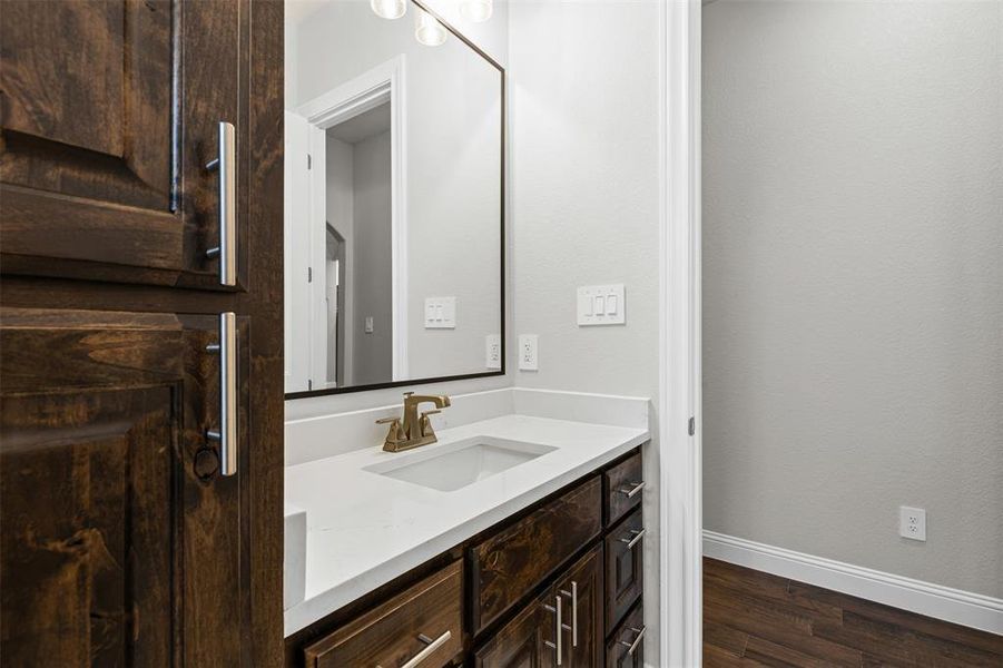 Bathroom with vanity and dark wood-style floors Bathroom with vanity and dark wood-style floors