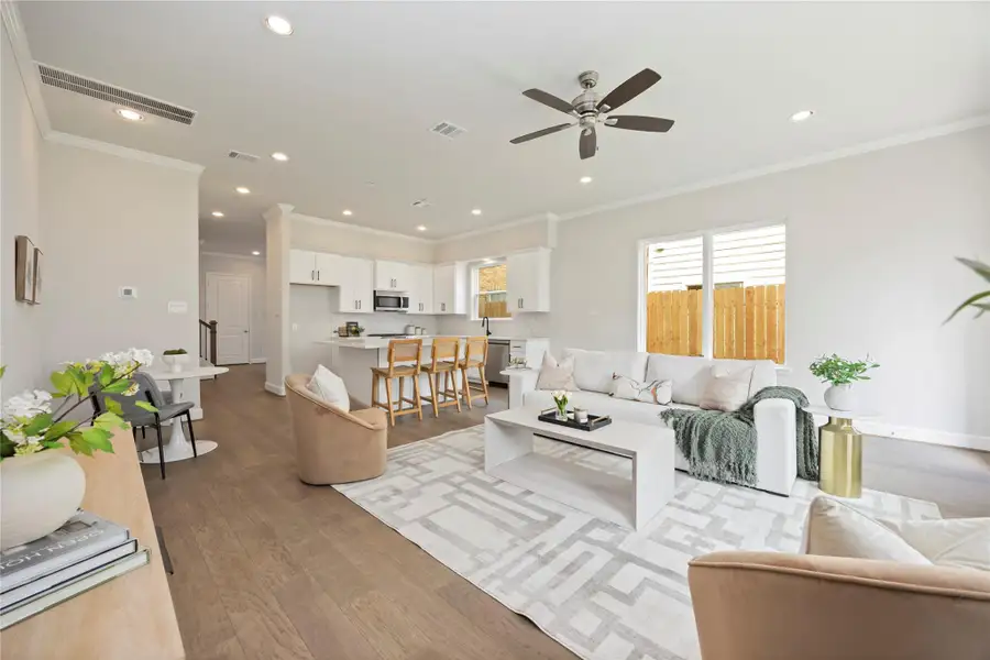 Recessed lighting and a stylish ceiling fan set the scene for tranquil evenings in the embrace of your expansive living room.