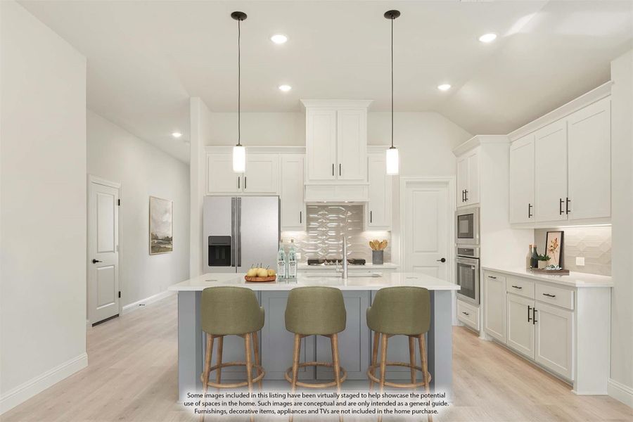 Kitchen with white cabinets, gray island, three bar stools, pendant lights, and stainless steel appliances