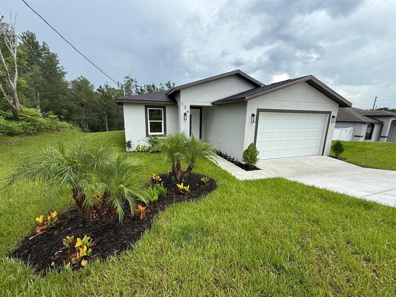 Front exterior of a new home in , Spring Hill, FL, highlighting curb appeal (Image 27). Front exterior of a new home in , Spring Hill, FL, highlighting curb appeal (Image 27).