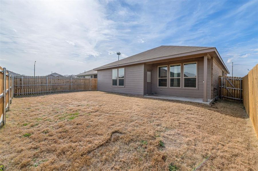 Rear view of house featuring a lawn