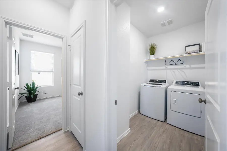 Laundry area featuring light wood-type flooring and washing machine and dryer