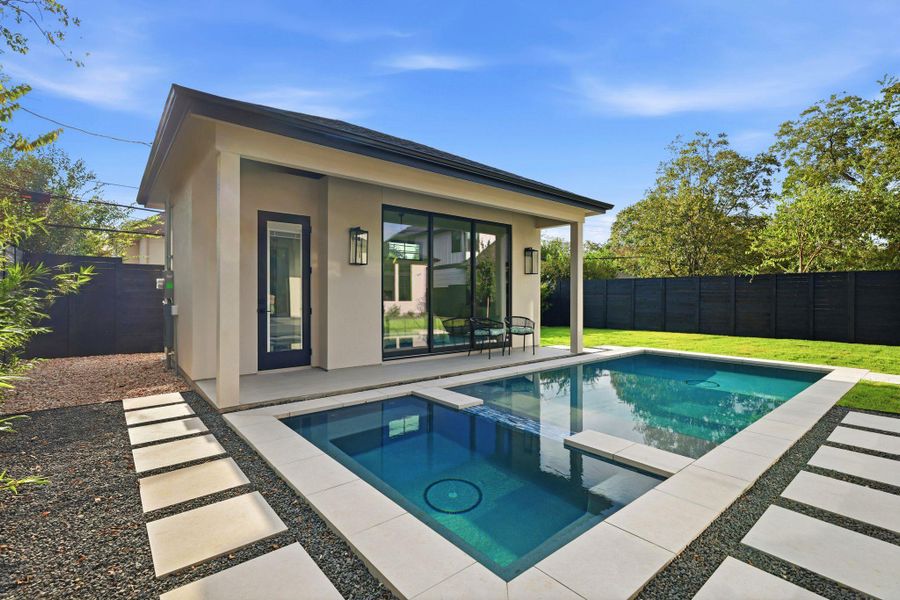 View of pool/hot tub and guest house from back patio of main house