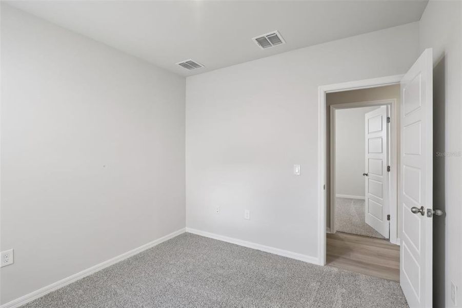 Spacious, unfurnished interior of a new home in Crescent Lakes - Premier Series, Punta Gorda (Image 22).