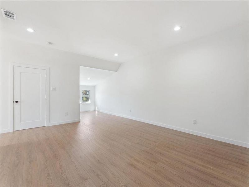 Spare room featuring visible vents, recessed lighting, light wood-style flooring, and baseboards