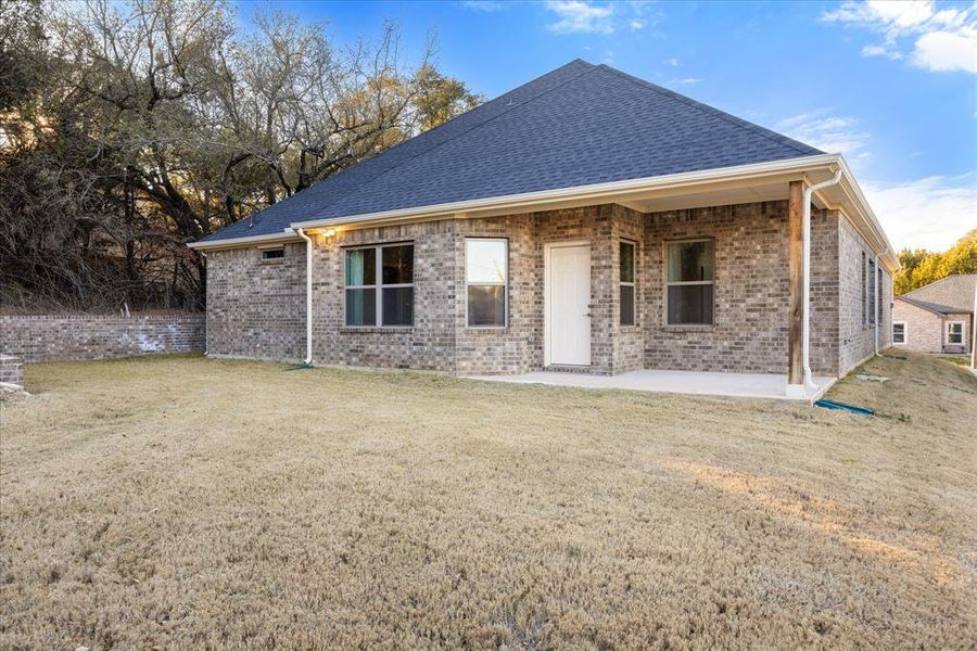 Back of property with a patio area and a yard