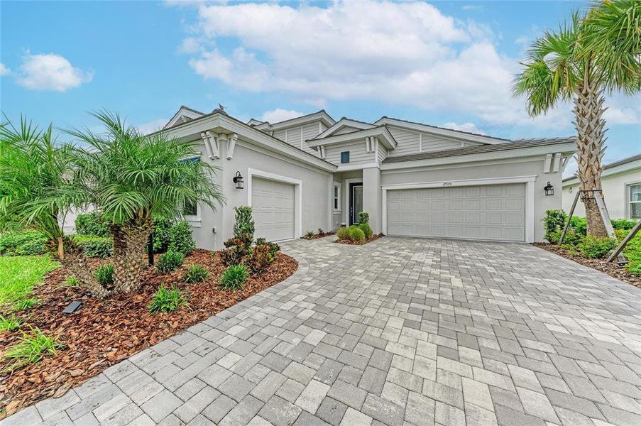 Front exterior of a new home in Star Farms at Lakewood Ranch, Lakewood Ranch, FL, highlighting curb appeal (Image 1). Front exterior of a new home in Star Farms at Lakewood Ranch, Lakewood Ranch, FL, highlighting curb appeal (Image 1).