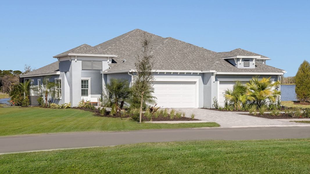 Front exterior of a new home in Wildleaf at North River Ranch, Parrish, FL, highlighting curb appeal (Image 16). Front exterior of a new home in Wildleaf at North River Ranch, Parrish, FL, highlighting curb appeal (Image 16).