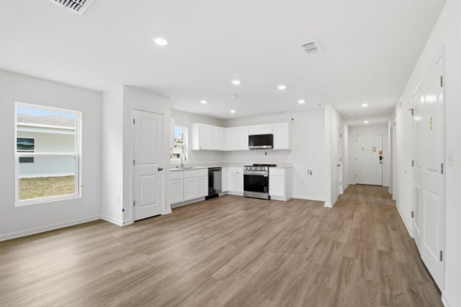A large white kitchen with white cabinets.