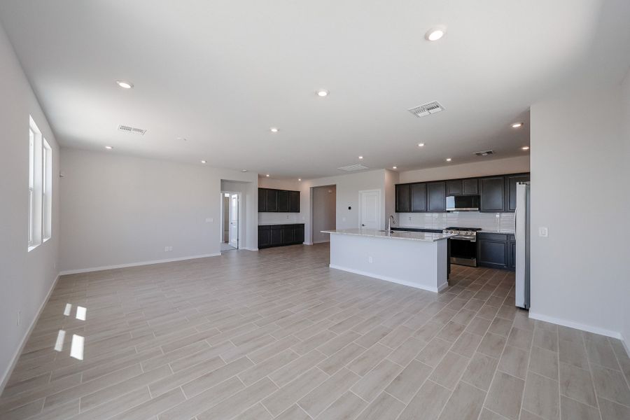A large kitchen with black cabinets.