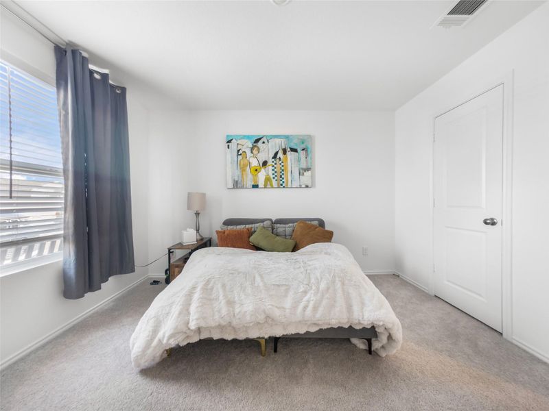 Carpeted bedroom with baseboards