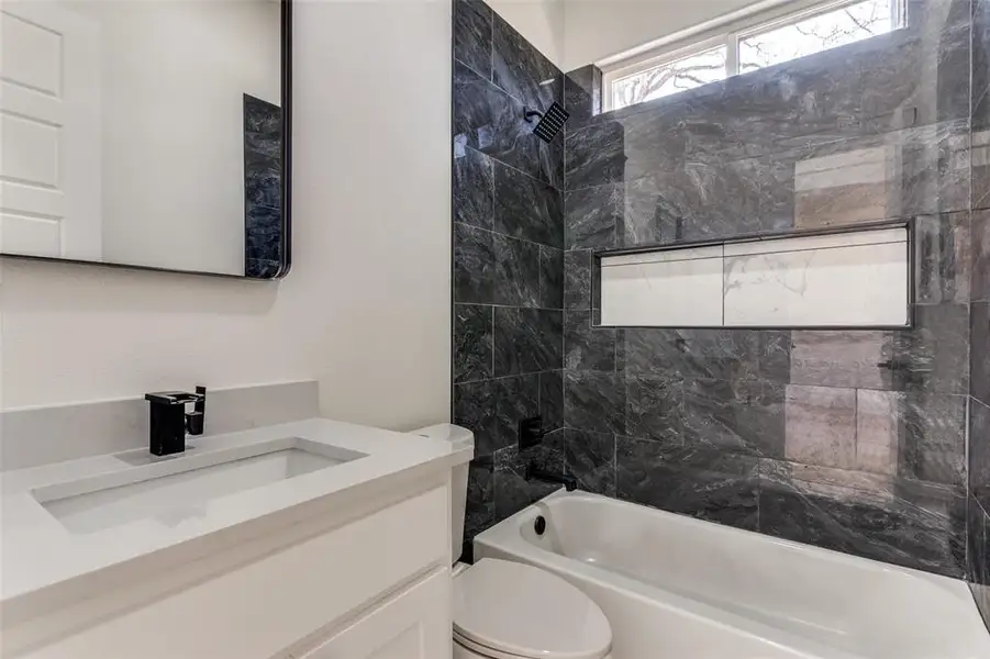 Full bath with toilet, vanity, and  shower combination