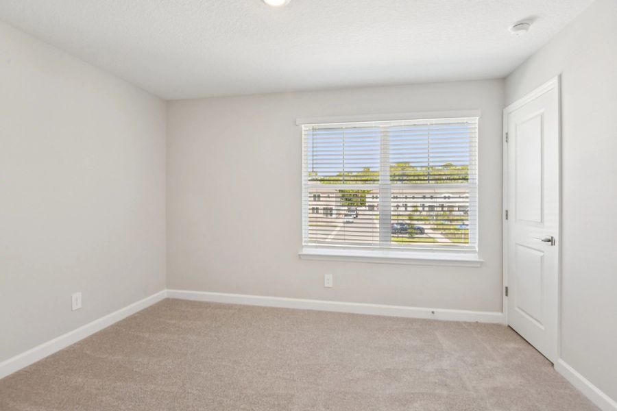 Bedroom 3 located at the front of the home and features a double window
