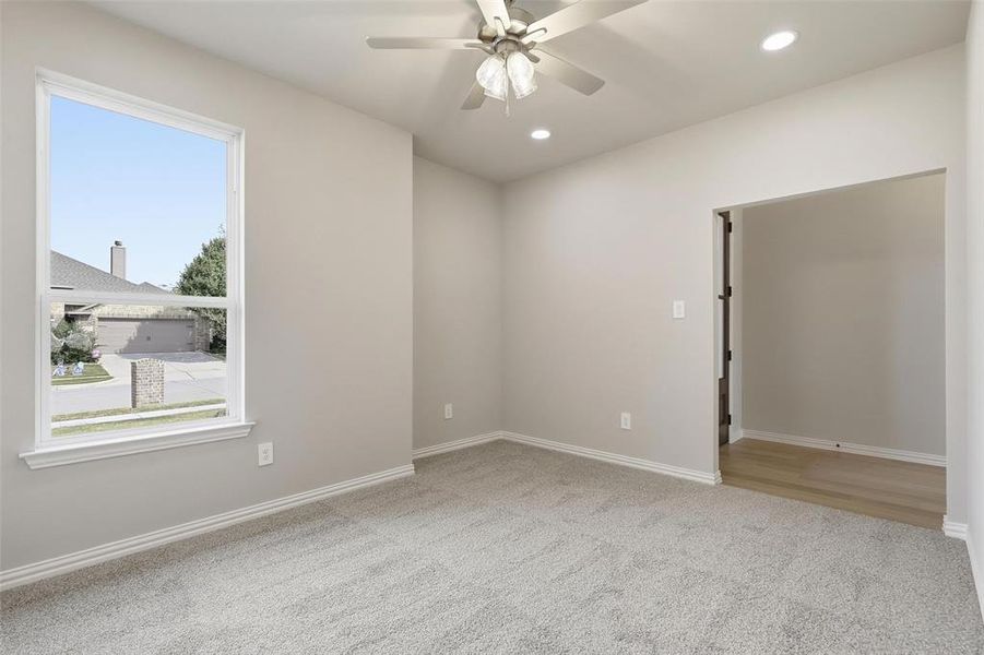 Empty room featuring light colored carpet, recessed lighting, and a ceiling fan Empty room featuring light colored carpet, recessed lighting, and a ceiling fan