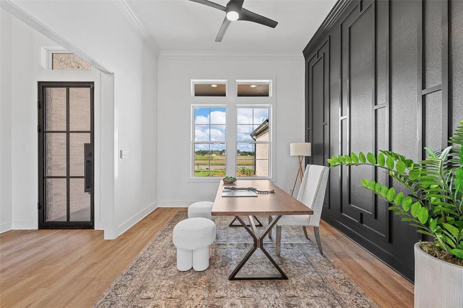Office area featuring light wood-type flooring, ornamental molding, and ceiling fan