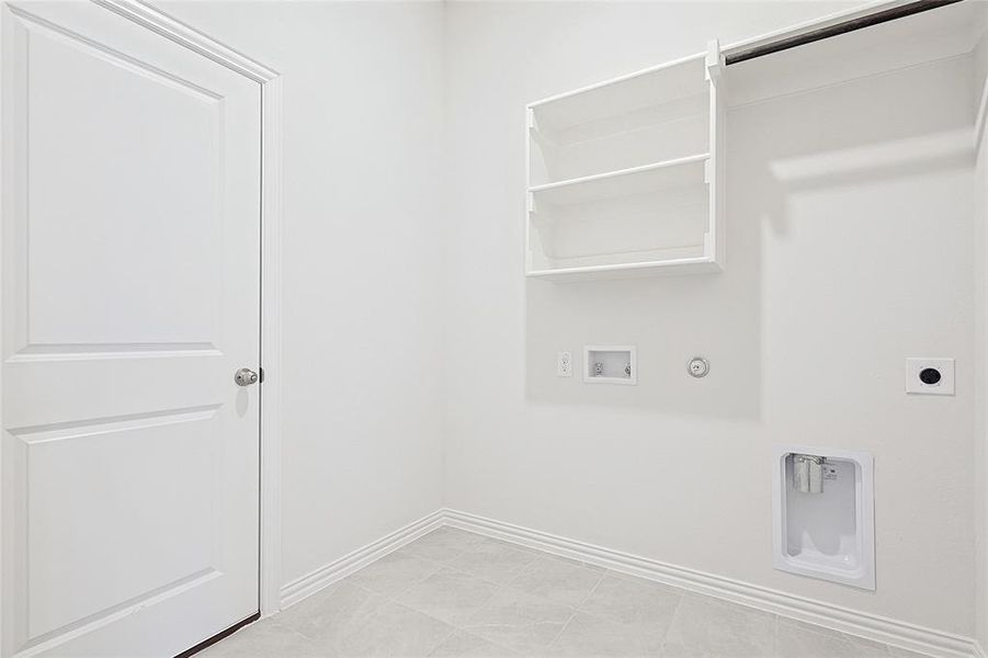 Laundry room featuring hookup for an electric dryer, hookup for a washing machine, light tile patterned floors, and hookup for a gas dryer