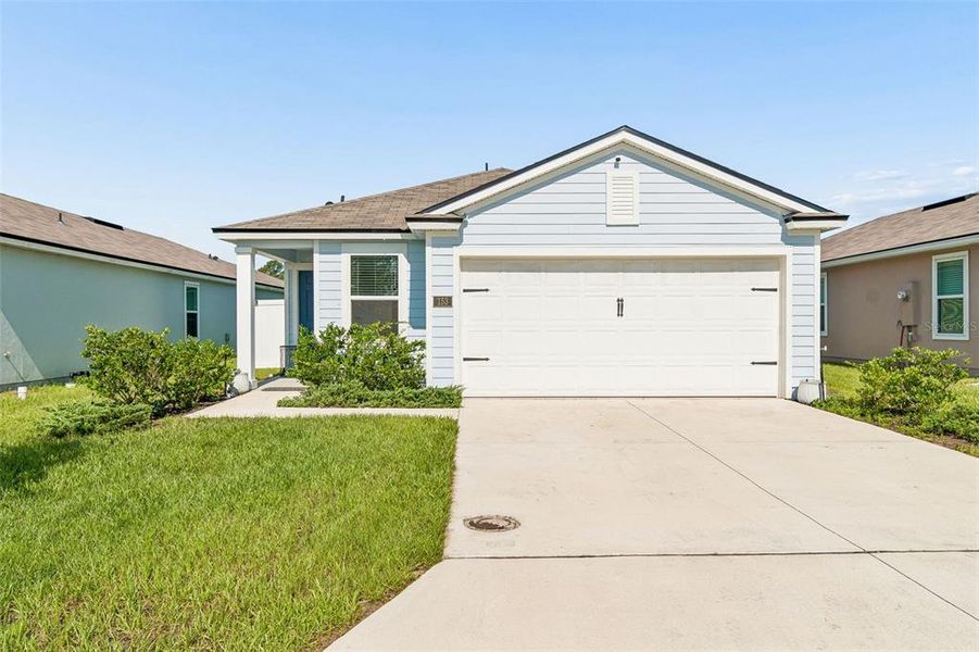 Front exterior of a new home in Ravenswood Village, St. Augustine, FL, highlighting curb appeal (Image 28). Front exterior of a new home in Ravenswood Village, St. Augustine, FL, highlighting curb appeal (Image 28).