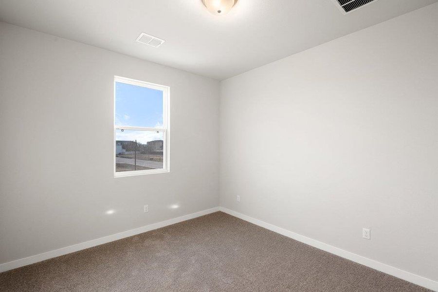 Empty room with baseboards and carpet floors