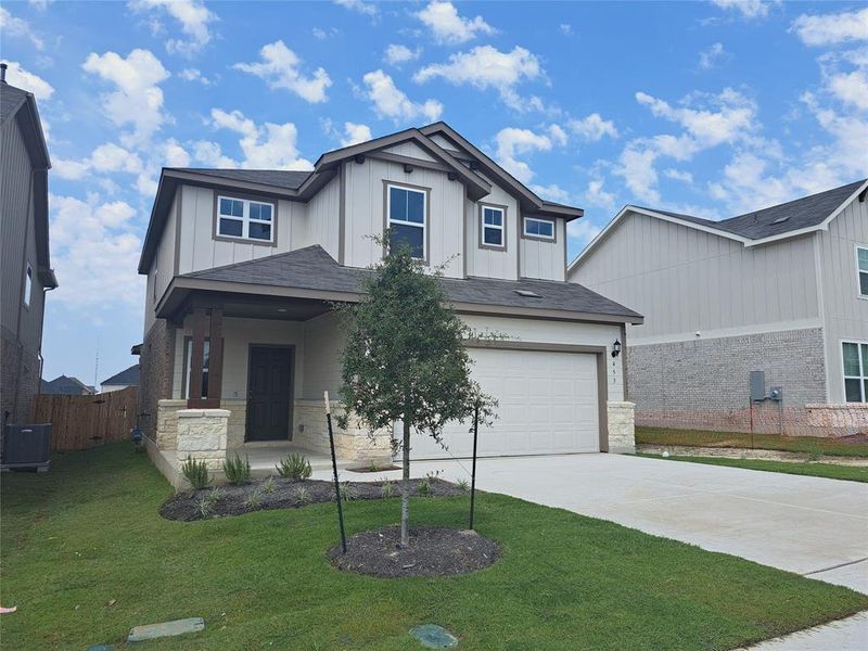 Front exterior of a new home in Sunfield, Buda, TX, highlighting curb appeal (Image 16). Front exterior of a new home in Sunfield, Buda, TX, highlighting curb appeal (Image 16).