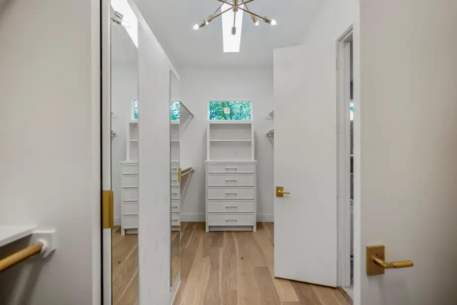 This 18 foot long primary closet is every owners dream! with fixed built-ins and plenty of space to give a department store feel. This 18 foot long primary closet is every owners dream! with fixed built-ins and plenty of space to give a department store feel.