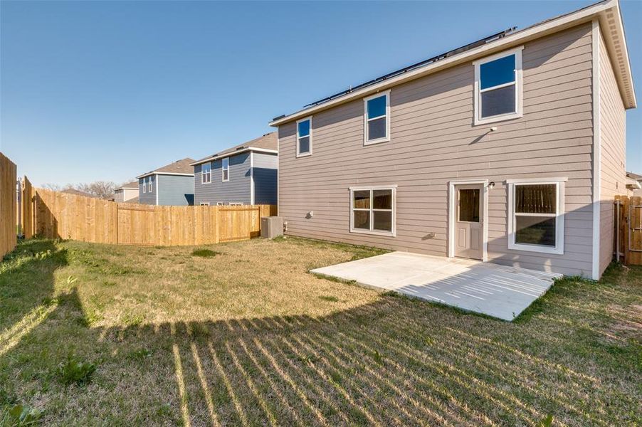 Rear view of house with a patio and a fenced backyard