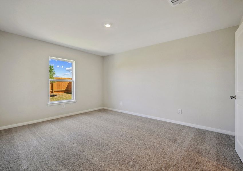 Master bedroom with a window overlooking the backyard Master bedroom with a window overlooking the backyard