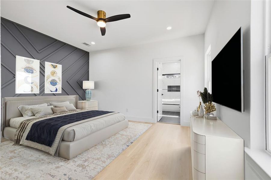 Bedroom featuring light wood finished floors, an accent wall, recessed lighting, ceiling fan, and ensuite bath Bedroom featuring light wood finished floors, an accent wall, recessed lighting, ceiling fan, and ensuite bath