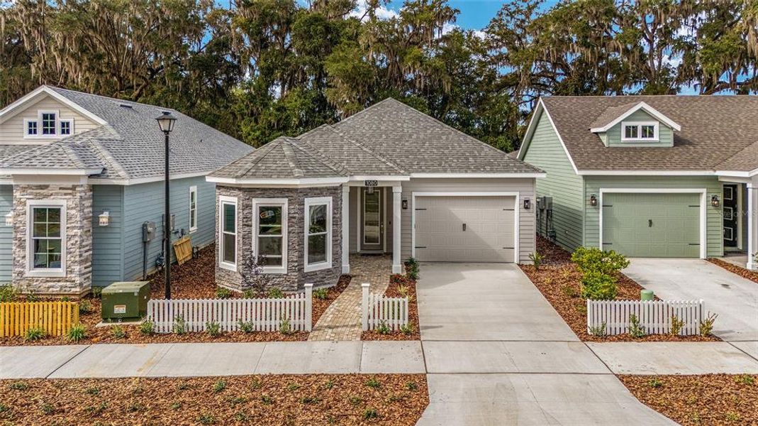 Front exterior of a new home in Fairway Pointe at West End, Newberry, FL, highlighting curb appeal (Image 18).