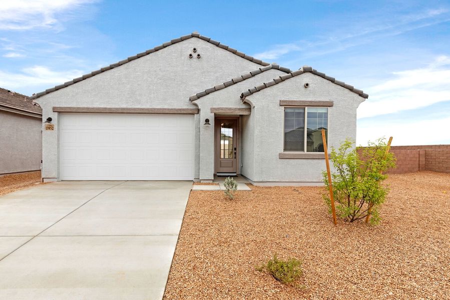 Front exterior of a new home in Oasis At Rocking K, Vail, AZ, highlighting curb appeal (Image 1). Front exterior of a new home in Oasis At Rocking K, Vail, AZ, highlighting curb appeal (Image 1).