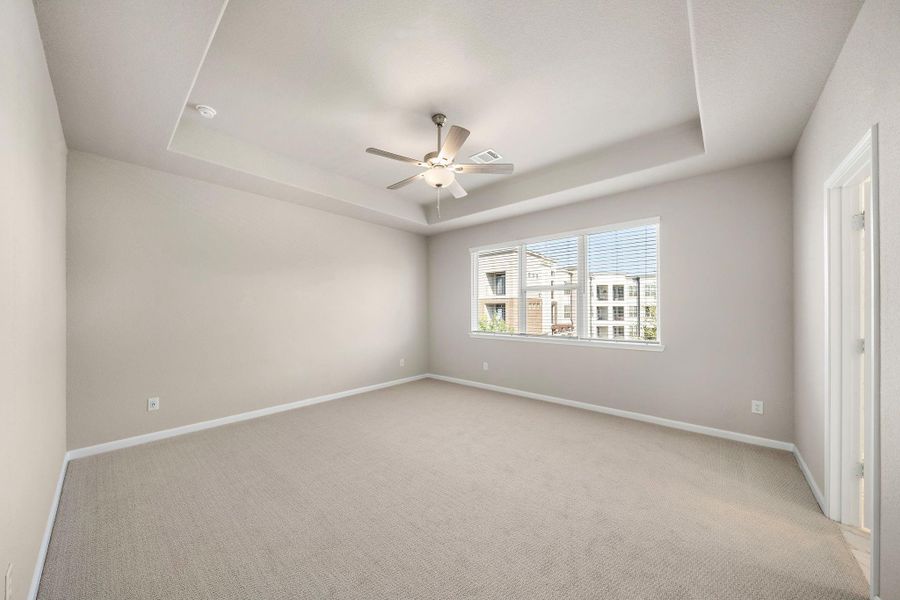 Large windows fill the room with natural light, creating a bright and airy atmosphere.